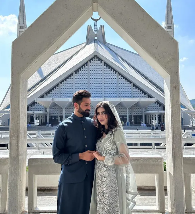 Couple posing together outside Faisal Mosque in Islamabad