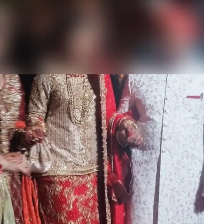 Bride and groom walking together in traditional Pakistani wedding attire