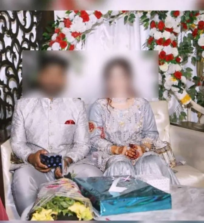 Couple on their Walima reception stage with gifts and floral decor